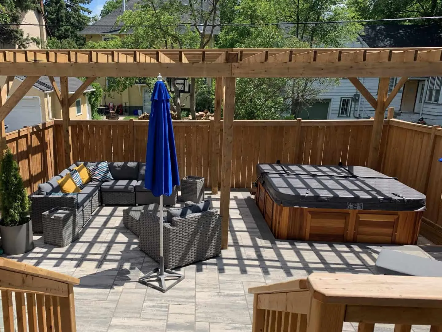 Paver patio and charcoal block retaining wall in a back yard