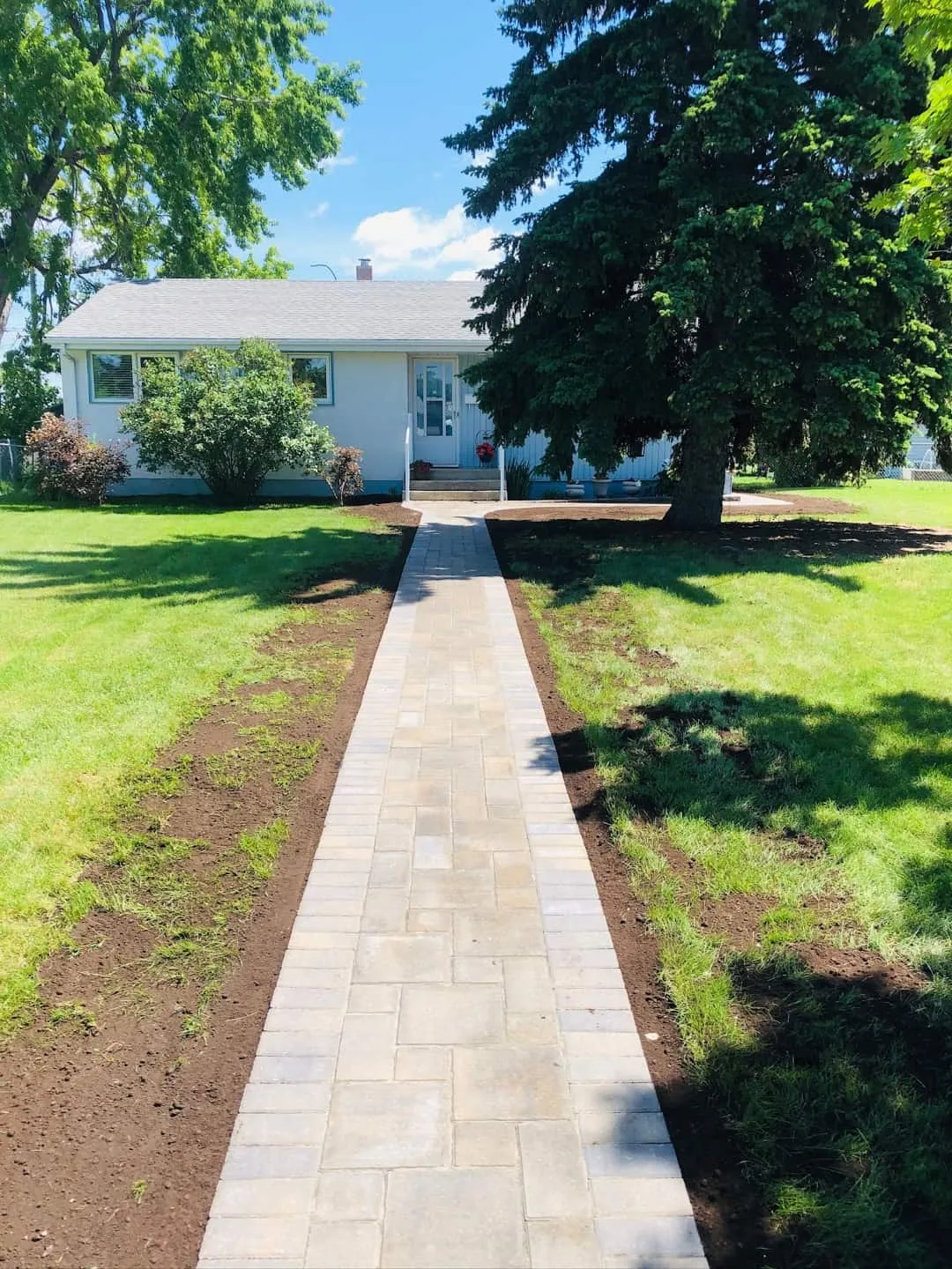 Paver walkway running from the street to a front entry
